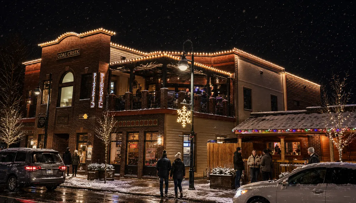 A Coal Creek property outlined in warm white bulbs with lit trees at dusk