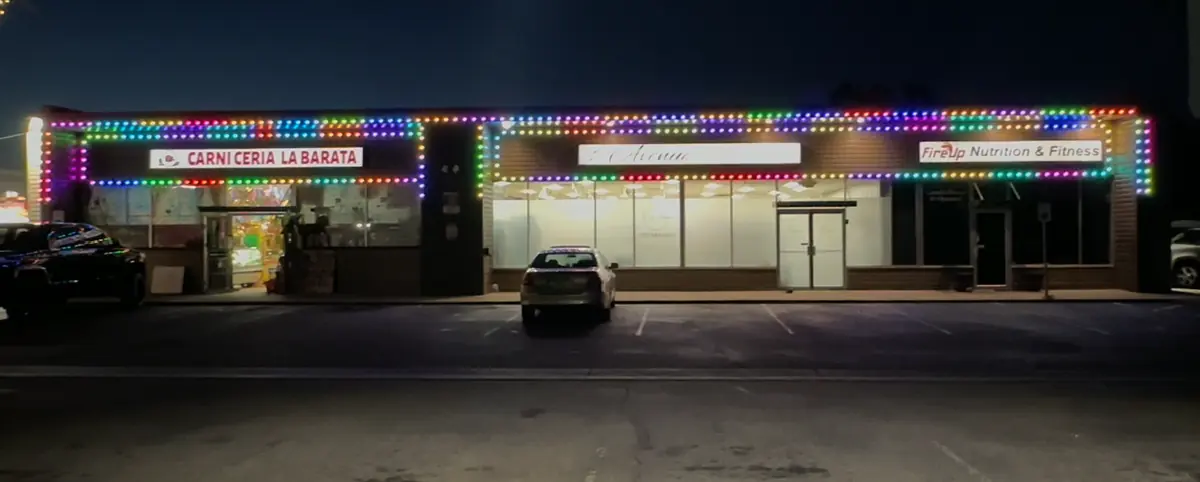 Building with permanent color-changing architectural lighting in red and green