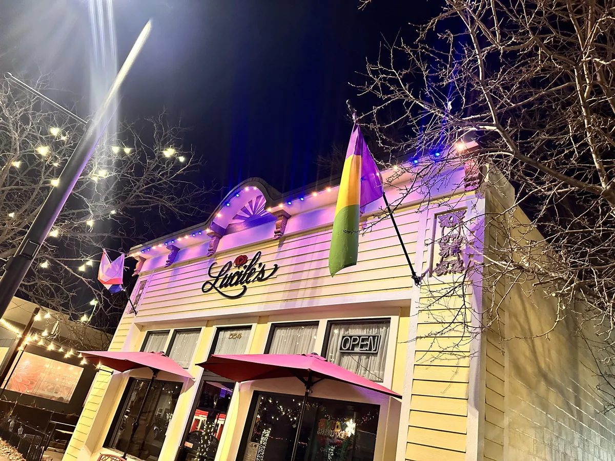 A downtown Erie storefront lit in color along the parapet and awning