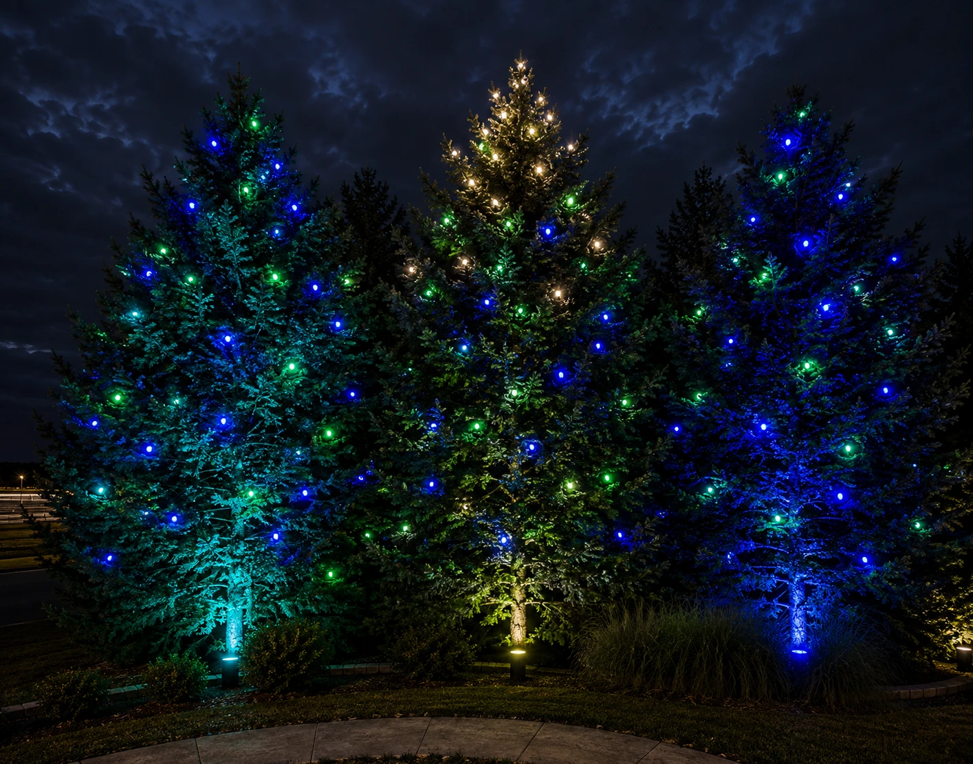 Ai Generated Mockup of three evergreens lit in blue, green and warm white with uplights at the trunks